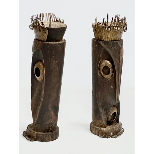 325 - A pair of 20th Century African style wood and brass candleholders. 30cm