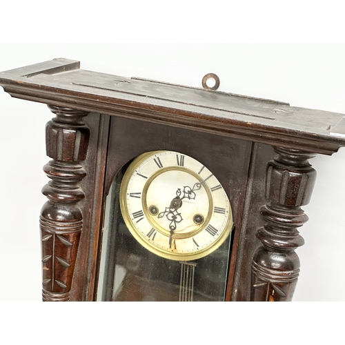 345 - A Late 19th Century Victorian mahogany Vienna wall clock. With key and pendulum. 42x64cm