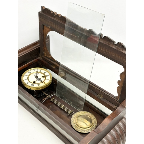 345 - A Late 19th Century Victorian mahogany Vienna wall clock. With key and pendulum. 42x64cm