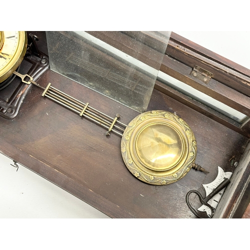 345 - A Late 19th Century Victorian mahogany Vienna wall clock. With key and pendulum. 42x64cm