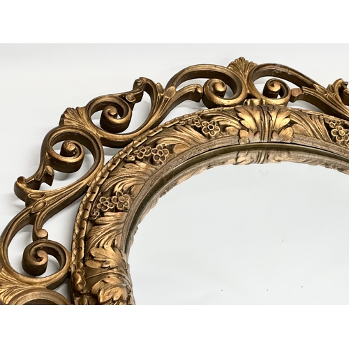 355 - A vintage Aisonia gilt framed convex mirror. 58cm