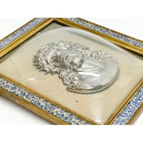 300 - A pair of Early 20th Century plated religious wall plaques with convex glass and gilt frames. 27x31.... 