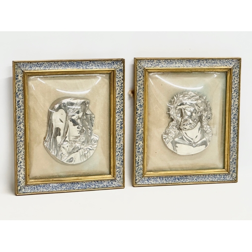 300 - A pair of Early 20th Century plated religious wall plaques with convex glass and gilt frames. 27x31.... 