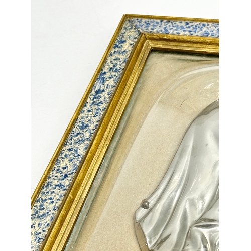 300 - A pair of Early 20th Century plated religious wall plaques with convex glass and gilt frames. 27x31.... 