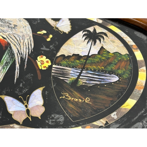 398 - A Mid 20th Century Brazilian serving tray with Mother of Pearl parrot and butterfly design. 70x41cm