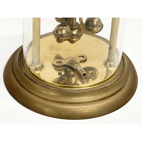 399D - An Early/Mid 20th Century brass anniversary clock with key. 18x26cm