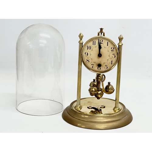 399D - An Early/Mid 20th Century brass anniversary clock with key. 18x26cm