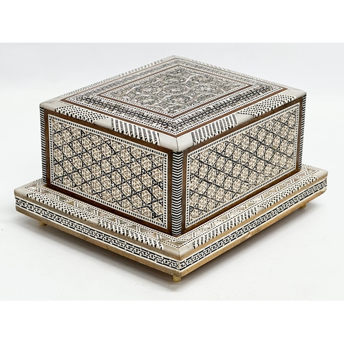 399 - A Mother of Pearl inlaid musical cigarette box. 19x17x11cm