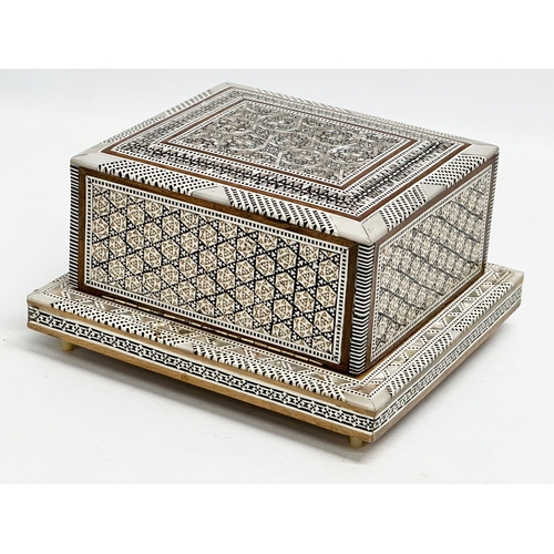 399 - A Mother of Pearl inlaid musical cigarette box. 19x17x11cm