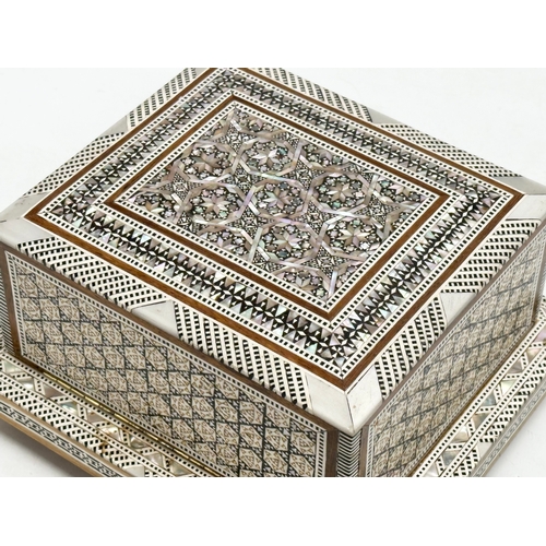 399 - A Mother of Pearl inlaid musical cigarette box. 19x17x11cm