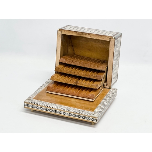 399 - A Mother of Pearl inlaid musical cigarette box. 19x17x11cm