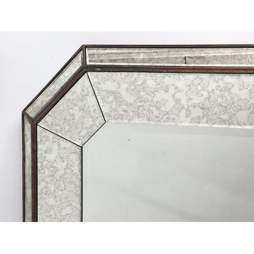 398B - A large bevelled distressed style wall mirror. 121x82cm