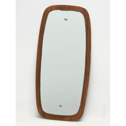 378 - A Mid Century teak framed mirror. 29x59cm