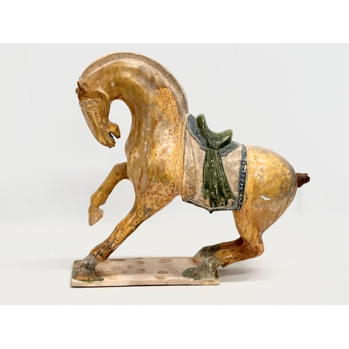 60A - A 19th Century Chinese Tang glazed terracotta horse. 36x36cm