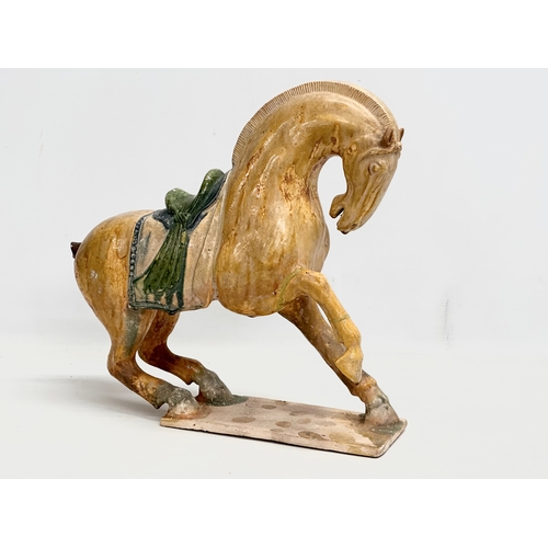 60A - A 19th Century Chinese Tang glazed terracotta horse. 36x36cm