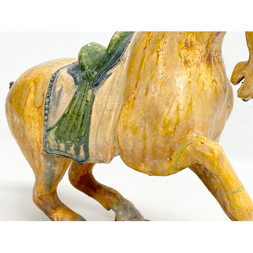 60A - A 19th Century Chinese Tang glazed terracotta horse. 36x36cm