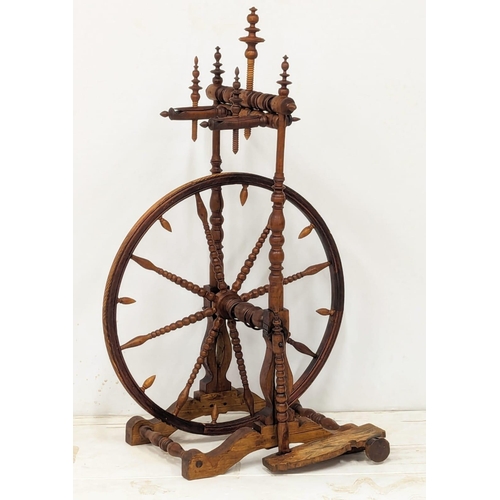 301 - An Early 20th Century spinning wheel. 62x108cm