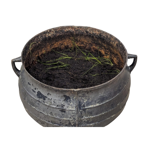 306 - A large Early 20th century cast iron garden planter / cauldron. 51x40cm