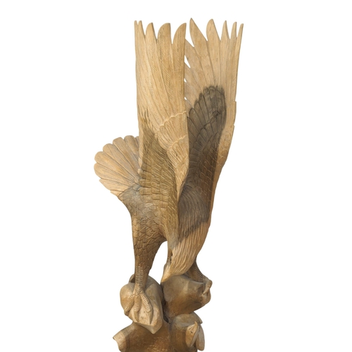 341 - A large carved wooden eagle. 119cm