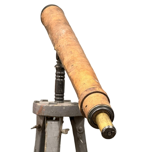 80 - A 19th/Early 20th Century leather bound telescope on tripod. 150cm