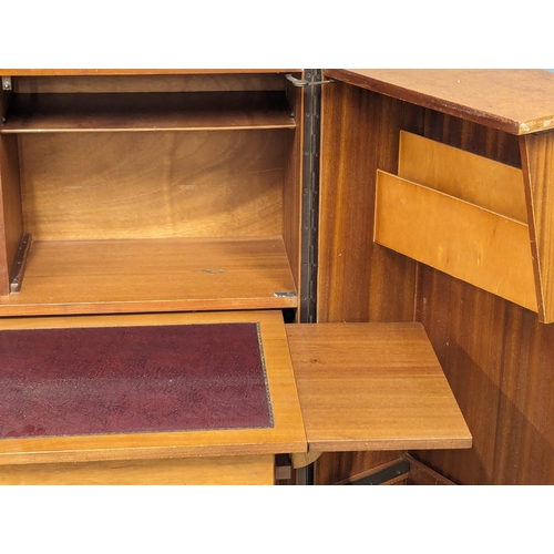 846 - A Mid Century teak home office fold away desk. 84x54x112cm