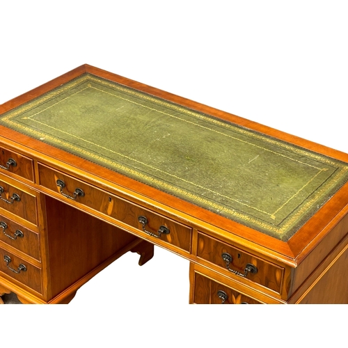 1246 - A George III style Yew wood pedestal desk with leather top.  121x60x76cm