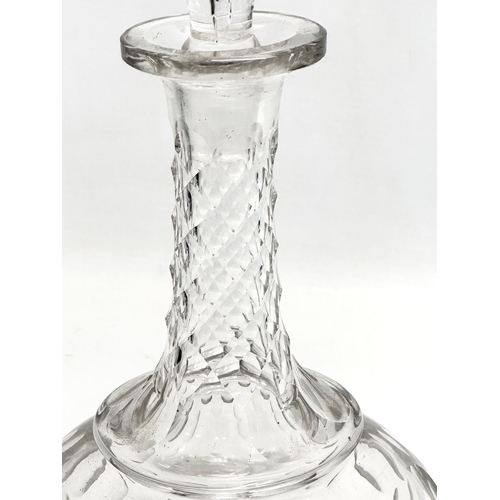 64 - A 19th Century Victorian lens cut decanter. 30.5cm