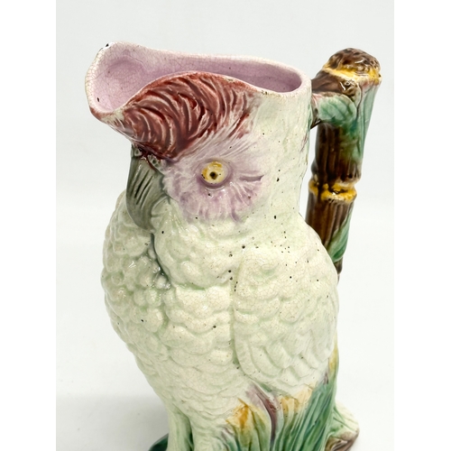 82 - A Late 19th Century Majolica parrot jug. 19x23cm