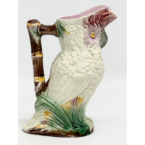 82 - A Late 19th Century Majolica parrot jug. 19x23cm