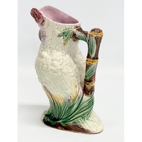 82 - A Late 19th Century Majolica parrot jug. 19x23cm