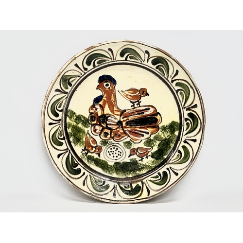 111 - A Transylvanian glazed earthenware Folk Art charger. Circa 1900. 30cm