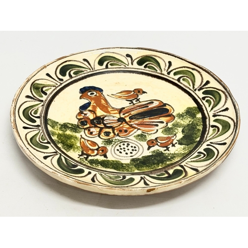 111 - A Transylvanian glazed earthenware Folk Art charger. Circa 1900. 30cm