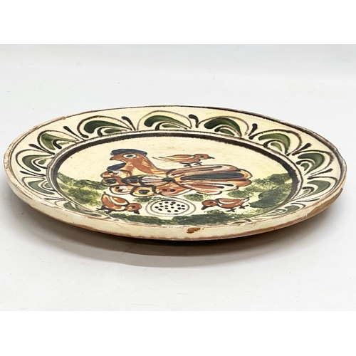 111 - A Transylvanian glazed earthenware Folk Art charger. Circa 1900. 30cm