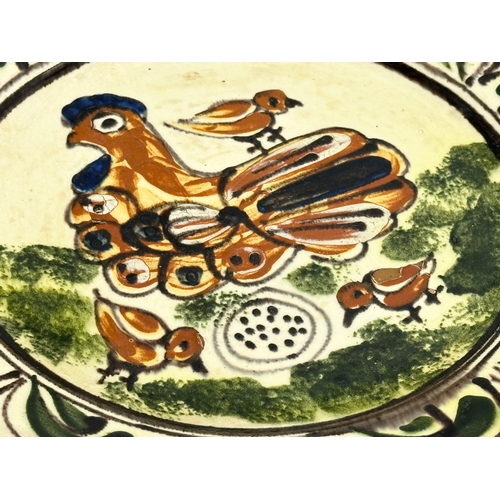 111 - A Transylvanian glazed earthenware Folk Art charger. Circa 1900. 30cm