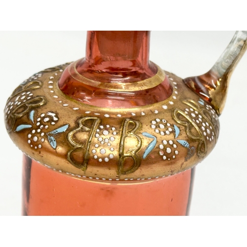 5 - An Early 19th Century French gilt cranberry glass decanter with original gilt brass holder and dropl... 