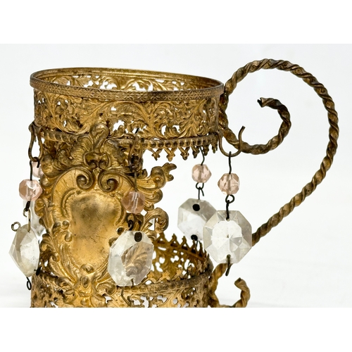 5 - An Early 19th Century French gilt cranberry glass decanter with original gilt brass holder and dropl... 