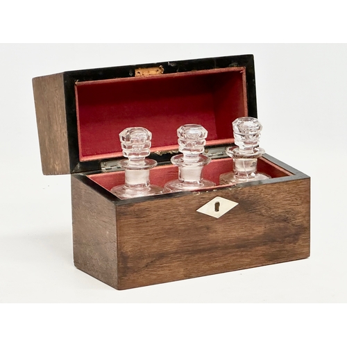 99 - Three Victorian cut glass perfume bottles in original rosewood presentation case with Mother of Pear... 