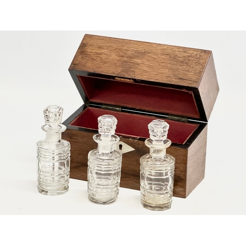 99 - Three Victorian cut glass perfume bottles in original rosewood presentation case with Mother of Pear... 