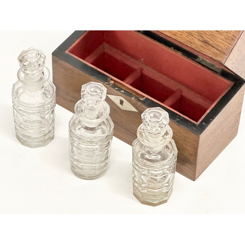 99 - Three Victorian cut glass perfume bottles in original rosewood presentation case with Mother of Pear... 