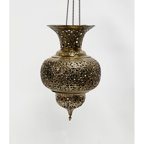 8 - An Early 20th Century Moroccan pierced brass Mosque ceiling light. Circa 1900.  21x34cm. 63cm includ... 