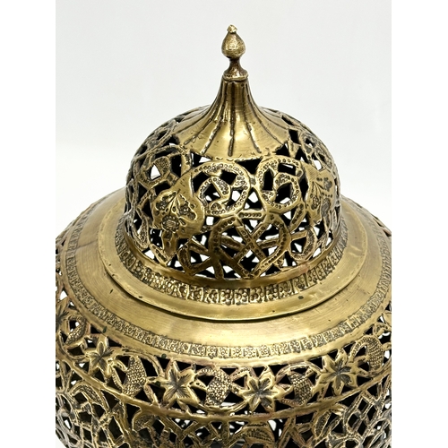 8 - An Early 20th Century Moroccan pierced brass Mosque ceiling light. Circa 1900.  21x34cm. 63cm includ... 