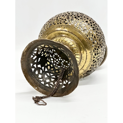 8 - An Early 20th Century Moroccan pierced brass Mosque ceiling light. Circa 1900.  21x34cm. 63cm includ... 