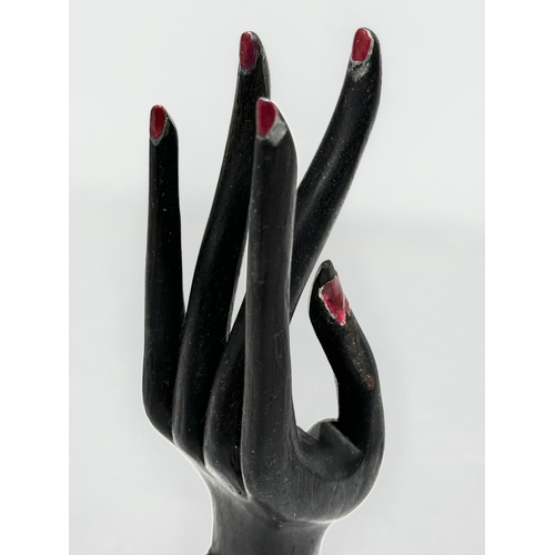 413 - A 20th Century Bali ebony dress ring display hand. 18cm