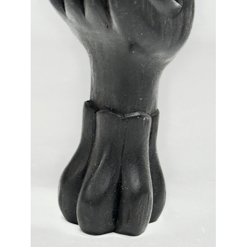 413 - A 20th Century Bali ebony dress ring display hand. 18cm