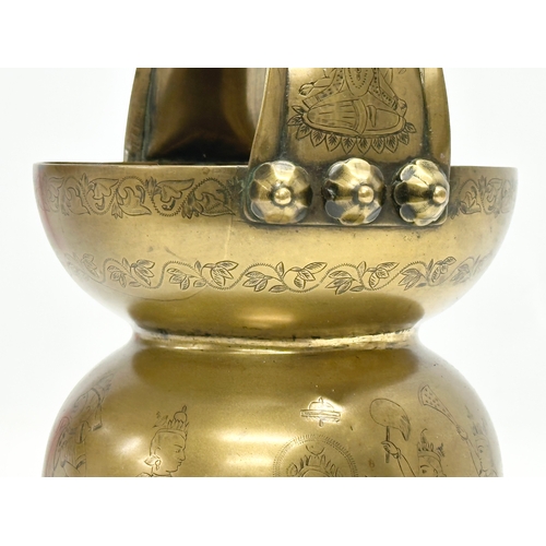 57 - An Early 20th Century Jeypore School of Arts, Indian brass holy water vessel. 16x15x26cm