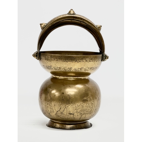 57 - An Early 20th Century Jeypore School of Arts, Indian brass holy water vessel. 16x15x26cm