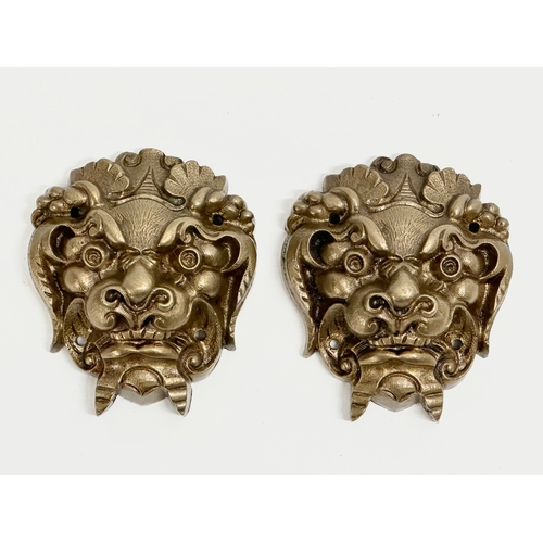 162 - A pair of brass Feng Shui mask wall mounts. Circa 1900. 7.5x9cm