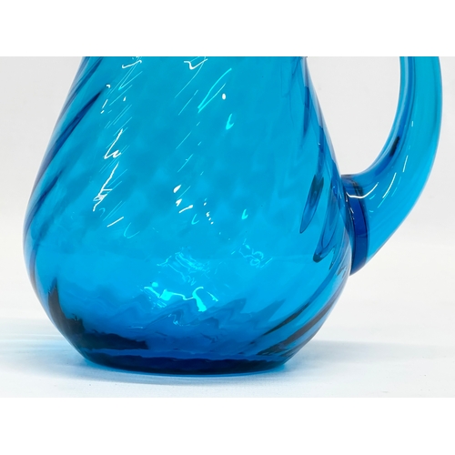 177 - A 1930’s blue swirl glass water jug. 15x11x15cm