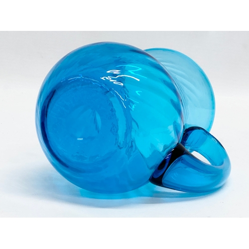 177 - A 1930’s blue swirl glass water jug. 15x11x15cm