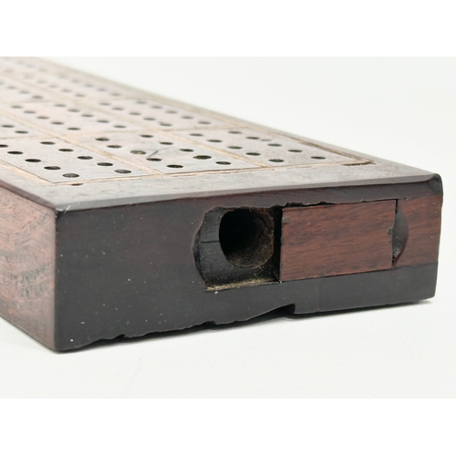 178 - A 19th Century rosewood cribbage board. 27.5x7.5x2.5cm